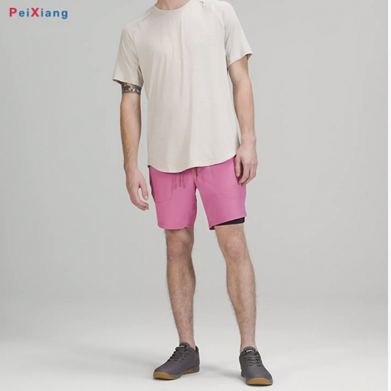 Man wearing pink athletic basketball shorts with t-shirt
