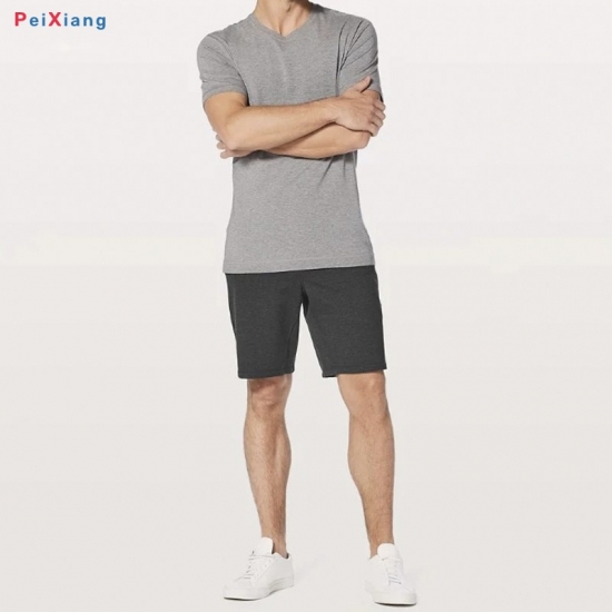 Man wearing black running shorts back view