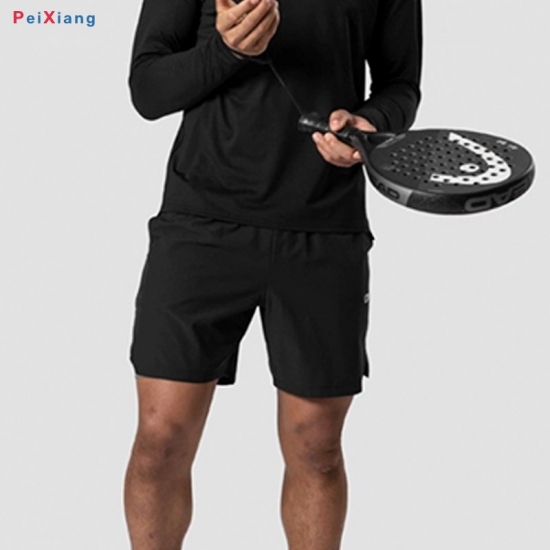 Man wearing black fitness training shorts with paddle