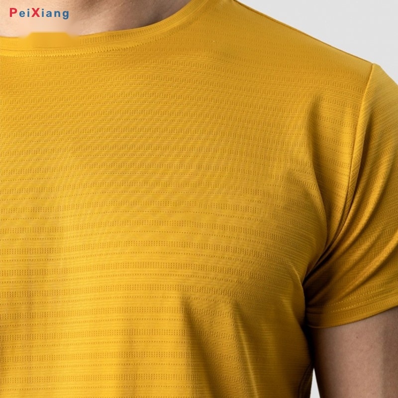 Men's mustard yellow cropped training tee fabric texture detail