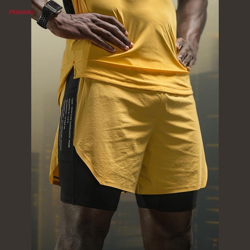 Model wearing PEIXIANG orange two-layer running shorts